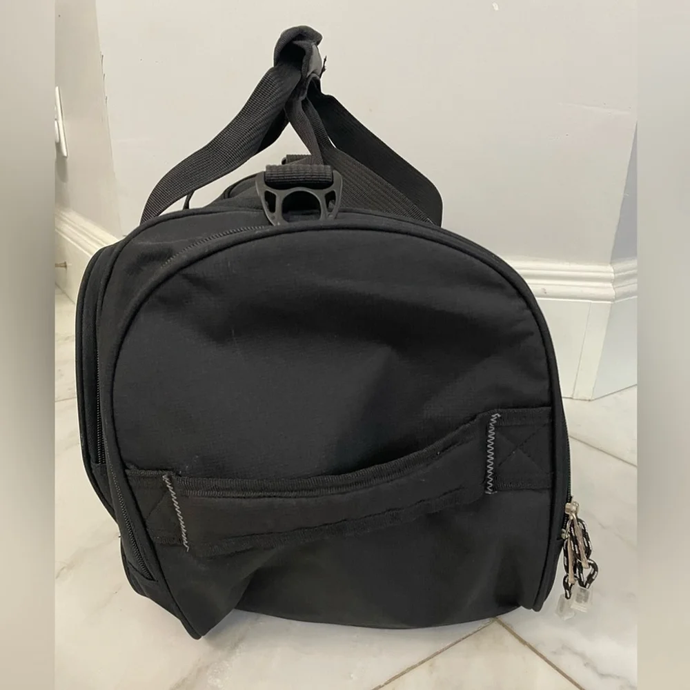 Calpak black canvas multi-pocket dual strap duffel bag travel luggage gym